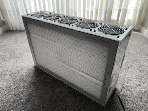 Corsi-Rosenthal Air Purifier, a rectangular box with fans on top and filter screens on the side.
