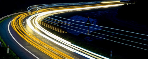 Long-exposure blurred lines of traffic on a highway.