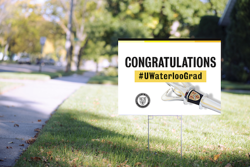A lawn sign on the University's ring road saying &quot;Congratulations #UWaterlooGrad.&quot;