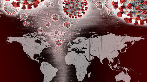 A map of the world with COVID virus particles hovering over it.