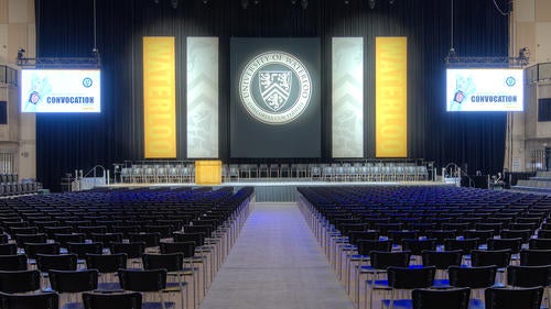 The stage setup for Spring 2018 Convocation prominently displaying the University seal.