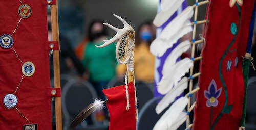 The eagle staff, with antlers and feather, held up at the recent ceremony in Fed Hall.
