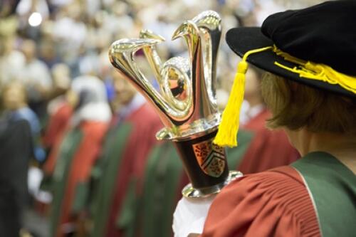 The ceremonial mace is carried into Convocation.