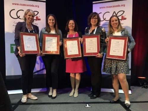 Waterloo staff accept awards at the CCAE national conference in Hamilton, on June 7; Cynthia Breen (Advancement), Christine Bezruki (AHS), Mary Stanley (Pharmacy), Pamela Smyth (University Relations), and Alex Farley (Advancement), who also received the Rising Star Award from CCAE.