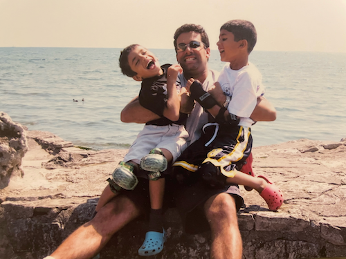 Alumns Ashi Mathur and his two sons at the beach.