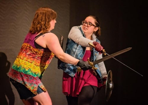 Two female actors engage in a swordfight.
