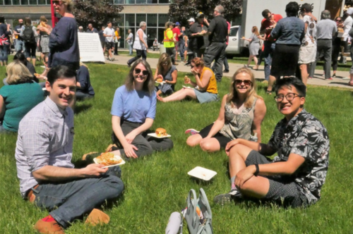 Employees sit on the grass at the Keystone Picnic.