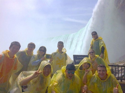 Students pose in front of Niagara Falls.