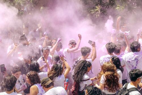 Engineering students are doused in (hopefully safe) purple paint clouds.