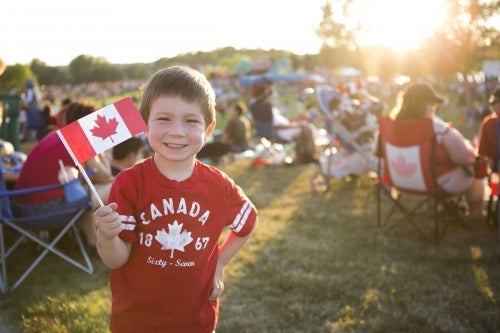 A child holds at Canada flag at the UW Canada Day celebration.