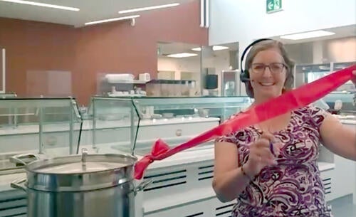 Food Services Manager Cheri Otterbein cuts the ribbon in Grebel’s new kitchen