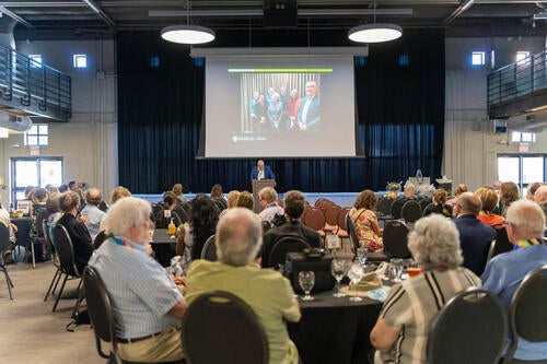 A picture of the audience and speaker at Dean Jean Andrey's farewell event.