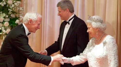 David Johnston shakes hands with Queen Elizabeth while Stephen Harper stands in the background.