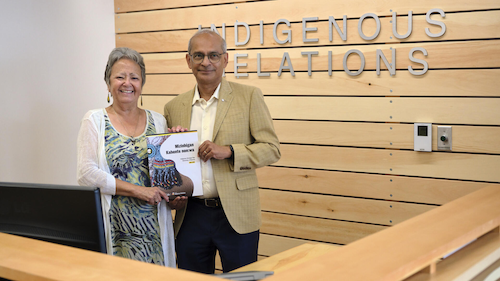 Jean Becker and Vivek Goel hold a copy of the Indigenous Strategic Plan.