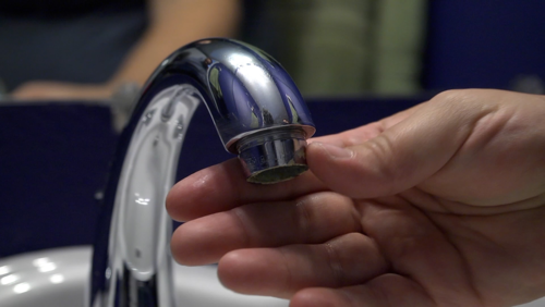 An aerator attached to a faucet.