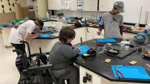 Students do electrical work in a lab at a high school in New Brunswick.
