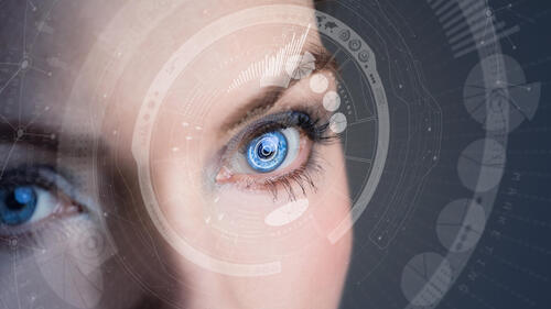 A stylized image of a woman wearing contact lenses that display augmented reality.