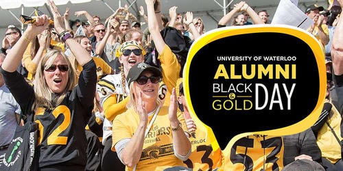 Waterloo alumni cheer at a sporting event for Alumni Black and Gold Day.