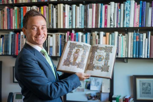 Professor Steven Bednarski with an illuminated medieval tome.