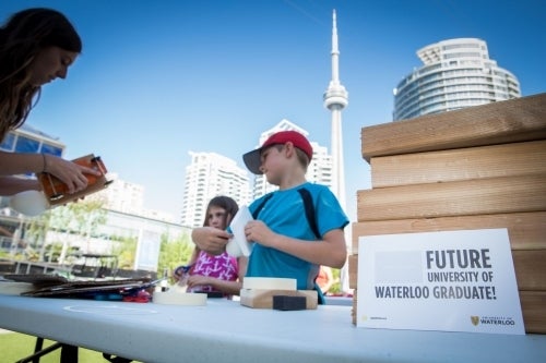 Children at the Waterloo booth with the CN Tower in the background.