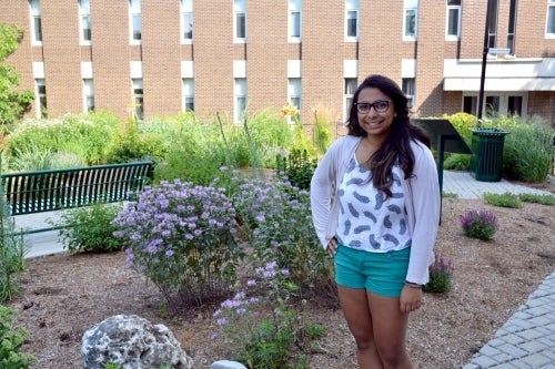 Aneetta Raviraj poses with the Arts-Environment garden.