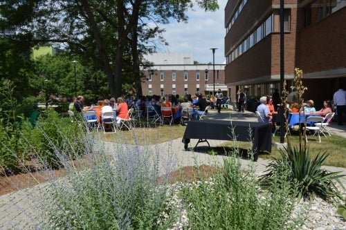 A lunch takes place with the garden in the foreground.