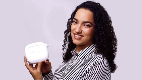 OrientaMED co-founder Jullia Nascimento holding the latest prototype of the breath-based diabetes monitor.