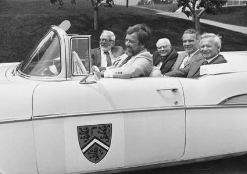 Bill Davis sits next to former presidents Burt Matthews and Gerry Hagey, with Doug Wright riding shotgun in a ’57 Chevy driven by Steve Little, chair of the University’s 25th anniversary committee.