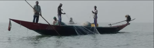 Three fishermen on a small flat-bottomed boat.