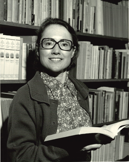 Professor Jennifer Ashworth holds a book in a library in a 1988 photo.