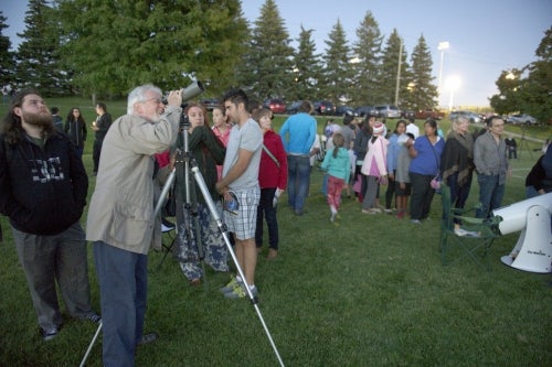 Participants in the meteor shower skywatching party look to the skies.