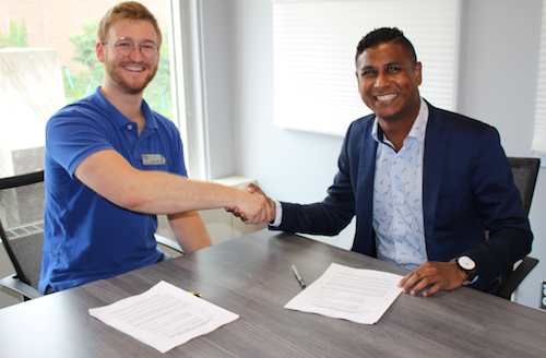 WUSA Vice President, Operations &amp; Finance Seneca Velling and Studentcare Ontario Program Manager Del Pereira (a former Feds VP himself) sign the legal representation agreement.