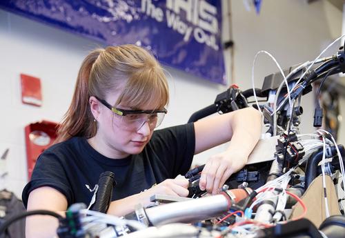 A female student works on a machine.
