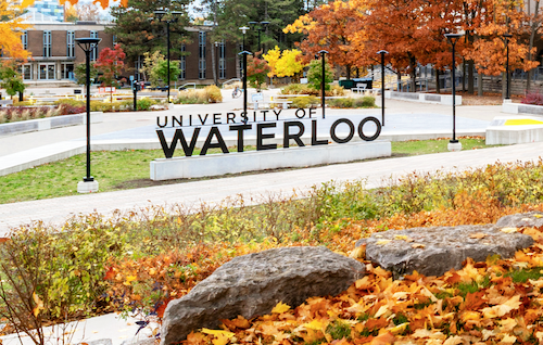 The University of Waterloo sign in an autumn setting.