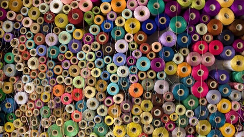 Spools of multicoloured threads and yarns.
