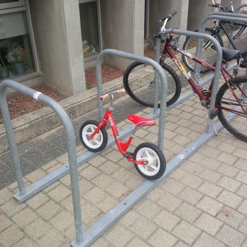 A child's bike at the Student Life Centre's bike rack.