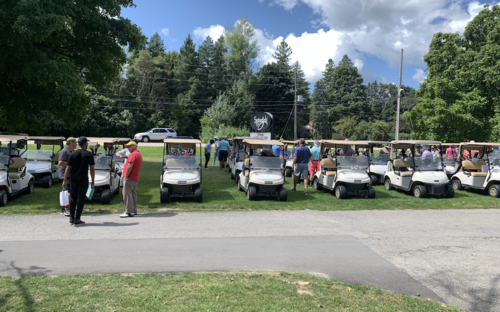 A lineup of golf carts and golfers at the Springfield Country Club.