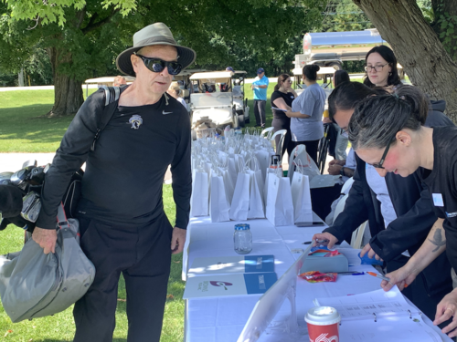 A golfer signs up to register for the tournament.