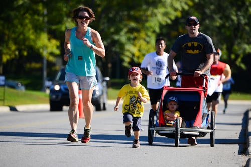 A family runs at the Fun Run.