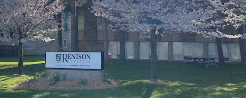 The Renison University College sign in front of an academic building.