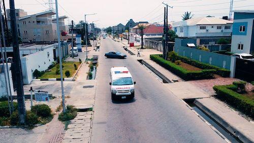 An Emergency Response Africa ambulance patrols a street in an African city.