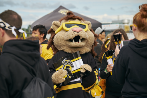 King Warrior mingles with the crowd at Homecoming sporting event.