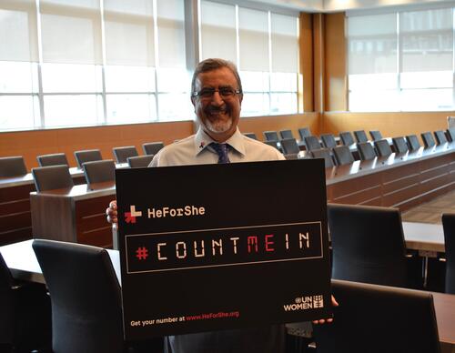 Feridun Hamdullahpur holds a &quot;Count Me In&quot; sign for HeForShe.