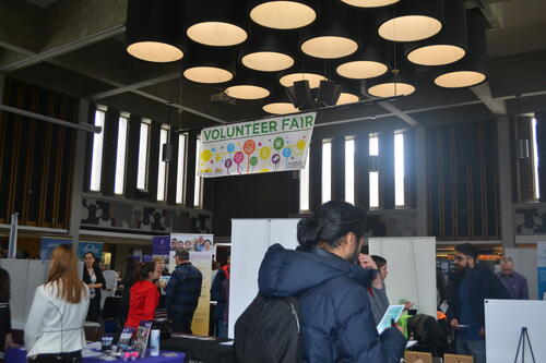 People look at booths at the volunteer fair in the SLC Great Hall.