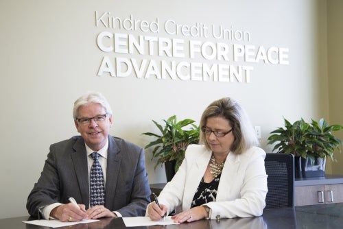 Kindred Chief executive officer Brent Zorgdrager and Conrad Grebel president Susan Schultz Huxman.