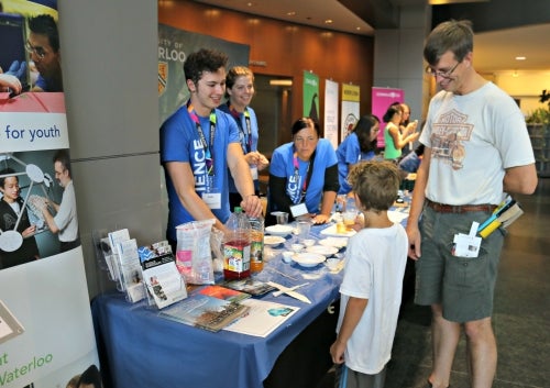 Science Outreach volunteers speak with Maker Expo participants.
