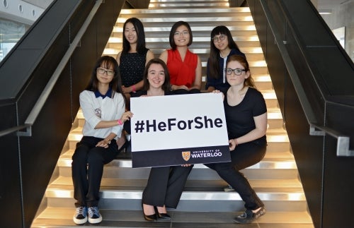 The six HeForShe scholarship winners pose with a sign that says #HeForShe.