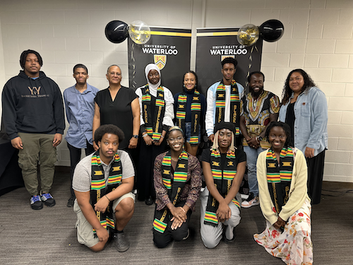 The initial cohort of Sankofa Pathways participants stand with University representatives.