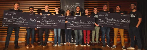 Velocity winners with their oversized cheques.