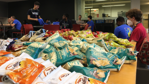 A table full of snacks for hackathon participants.